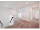 Upstairs hallway featuring neutral carpet, white walls and trim and lots of natural light at 5719 Cattle Ranch Dr, St Cloud, FL 34771