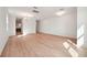 Expansive living area with beautiful hardwood floors that flow seamlessly into the adjacent rooms, bathed in sunlight at 5719 Cattle Ranch Dr, St Cloud, FL 34771