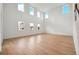 Open living room with bright, natural light and wood-look flooring at 5719 Cattle Ranch Dr, St Cloud, FL 34771
