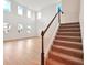 Bright living room with wood floors, staircase, and many windows letting in natural light at 5719 Cattle Ranch Dr, St Cloud, FL 34771