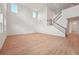 Living room boasts wood floors, high ceilings, and a modern staircase at 5719 Cattle Ranch Dr, St Cloud, FL 34771