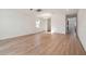 Spacious living room with wood-look floors, a modern light fixture, and neutral paint at 5719 Cattle Ranch Dr, St Cloud, FL 34771