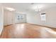 Bright, open living room with wood-look flooring and ample natural light from multiple windows at 5719 Cattle Ranch Dr, St Cloud, FL 34771