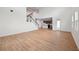 Bright living room with high ceilings, wood flooring, and a view into the kitchen at 5719 Cattle Ranch Dr, St Cloud, FL 34771