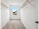 Walk in closet with white walls and trim and shelving with a view outside at 5719 Cattle Ranch Dr, St Cloud, FL 34771
