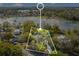 Aerial view showing the home nestled among trees with a lake nearby at 5850 Sheryl Anita St, Oviedo, FL 32765