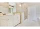 Bright bathroom with double vanity, tiled floor, and glass shower enclosure at 5850 Sheryl Anita St, Oviedo, FL 32765