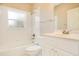 Bright, white bathroom with a shower, bathtub, and vanity sink at 5850 Sheryl Anita St, Oviedo, FL 32765