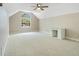 Upstairs bonus room featuring a vaulted ceiling, soft carpet and a built-in desk area at 5850 Sheryl Anita St, Oviedo, FL 32765