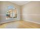 Bedroom featuring hardwood floors, a large window, and neutral-colored walls at 5850 Sheryl Anita St, Oviedo, FL 32765