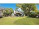 Exterior view of home surrounded by well-manicured lawn and mature trees at 5850 Sheryl Anita St, Oviedo, FL 32765