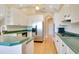 Spacious kitchen featuring white cabinets, stainless steel refrigerator, and a convenient gas cooktop at 5850 Sheryl Anita St, Oviedo, FL 32765