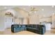 Open-concept living room featuring a high ceiling, ceiling fan, and views of the kitchen at 5850 Sheryl Anita St, Oviedo, FL 32765