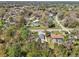 An aerial perspective of a residential street and a new house amid the green foliage of the area at 6551 Hemlock Rd, Ocala, FL 34472