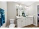 Bright bathroom featuring double sinks, quartz countertops, gold hardware, and decorative accents at 6551 Hemlock Rd, Ocala, FL 34472