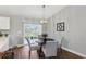 Bright eat-in kitchen features a sliding glass door, a dark table, and seating for four at 6551 Hemlock Rd, Ocala, FL 34472