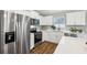 Bright kitchen with stainless steel appliances, white cabinetry, quartz countertops, and modern fixtures at 6551 Hemlock Rd, Ocala, FL 34472
