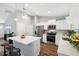 Bright kitchen with stainless steel appliances, granite counter tops, white cabinets, and hardwood floors at 6551 Hemlock Rd, Ocala, FL 34472