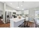 Modern kitchen featuring an island with seating, stainless steel appliances, and hardwood floors at 6551 Hemlock Rd, Ocala, FL 34472
