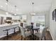 Stylish eat-in kitchen featuring white cabinets, stainless steel appliances and hardwood floors at 6551 Hemlock Rd, Ocala, FL 34472