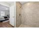 Tiled walk-in shower featuring a rainfall shower head and modern fixtures at 6551 Hemlock Rd, Ocala, FL 34472