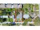 An aerial view of a well-maintained single-Gathering home surrounded by lush greenery and neighboring houses at 714 Kankakee Ln, Orlando, FL 32807