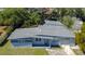An aerial view of a freshly painted single-story home with a clean roof and lush, green lawn at 714 Kankakee Ln, Orlando, FL 32807