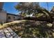 Backyard featuring a lawn, patio, mature tree, and lounge chairs at 714 Kankakee Ln, Orlando, FL 32807