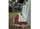 Exterior view showcasing the stone tile pathway, mulch and white stone border in the backyard at 714 Kankakee Ln, Orlando, FL 32807