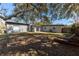 Backyard featuring a large lawn and mature trees at 714 Kankakee Ln, Orlando, FL 32807