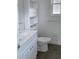 Bathroom featuring a white sink, toilet, and built-in shelves at 714 Kankakee Ln, Orlando, FL 32807