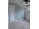 Spacious bedroom featuring neutral carpeting, a ceiling fan, and ample closet space for storage at 714 Kankakee Ln, Orlando, FL 32807