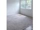 Bright bedroom with large window, fresh paint, carpet and wood-look flooring at 714 Kankakee Ln, Orlando, FL 32807