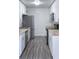 Galley kitchen featuring stainless steel appliances, white cabinetry, and butcher block countertops at 714 Kankakee Ln, Orlando, FL 32807