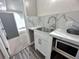 Functional kitchenette with stainless sink, microwave, sleek countertops, and stylish backsplash at 714 Kankakee Ln, Orlando, FL 32807