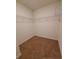Walk-in closet offering ample storage space with wire shelving and neutral carpet at 717 Squires Grove Dr, Winter Haven, FL 33880