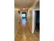 Inviting hallway featuring neutral walls, tile flooring and arched doorways that lead to the living areas at 717 Squires Grove Dr, Winter Haven, FL 33880