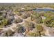 Overhead shot of a suburban home near a tranquil pond and lush greenery at 75 Chaney Dr, Casselberry, FL 32707