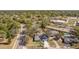 Aerial view of a home in a wooded neighborhood near a school at 75 Chaney Dr, Casselberry, FL 32707