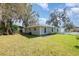 A spacious backyard is complemented by lush green grass and mature trees, offering serene outdoor living at 75 Chaney Dr, Casselberry, FL 32707