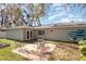 Landscaped backyard with brick patio and seating area at 75 Chaney Dr, Casselberry, FL 32707