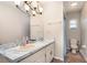 Bathroom with dual sinks, marbled countertops, and overhead vanity lights at 75 Chaney Dr, Casselberry, FL 32707