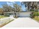 Well-maintained home showcasing a spacious driveway with mature landscaping, enhancing its curb appeal at 75 Chaney Dr, Casselberry, FL 32707