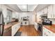 Spacious kitchen with ample white cabinetry, tile floors, and stainless steel appliances for modern convenience at 75 Chaney Dr, Casselberry, FL 32707