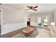 Cozy living room with a ceiling fan, french doors, and white trim at 75 Chaney Dr, Casselberry, FL 32707