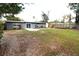 Backyard featuring sliding glass doors and large concrete patio for outdoor enjoyment at 904 Crestwood Ln, Altamonte Springs, FL 32701