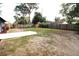 Fenced backyard with lush greenery and a concrete patio, offering a private outdoor space at 904 Crestwood Ln, Altamonte Springs, FL 32701