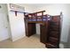 Cozy bedroom featuring a wooden loft bed with built-in storage and staircase at 904 Crestwood Ln, Altamonte Springs, FL 32701
