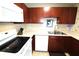 Well-lit kitchen featuring white appliances, wooden cabinets, and tile floors at 904 Crestwood Ln, Altamonte Springs, FL 32701