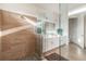 Bathroom featuring a double vanity and a glass-enclosed shower with stone floors at 3881 Sonoma Blvd, Kissimmee, FL 34741